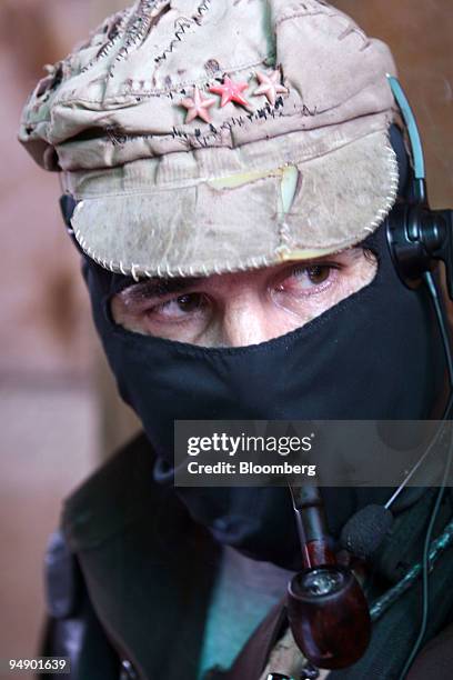 Zapatista rebel leader Subcomandante Marcos smokes a pipe during a meeting with members of the Dolores Hidalgo commune in the State of Chiapas in...