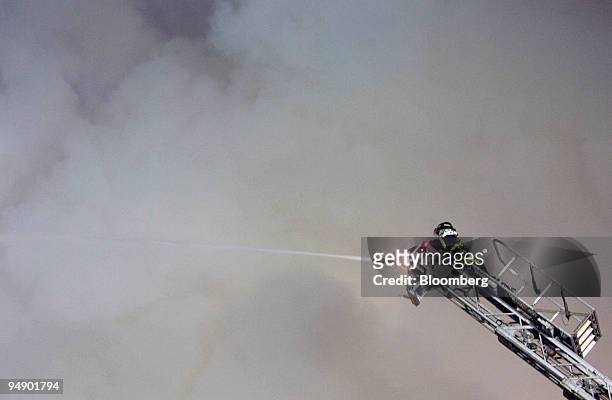 Firefighters try to extinguish a fire at Sungnyemun Gate, also called Namdaemun, or South Gate, in Seoul, South Korea, on Monday, Feb. 11, 2008. Fire...