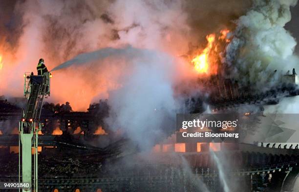 Firefighters try to extinguish a fire at Sungnyemun Gate, also called Namdaemun, or South Gate, in Seoul, South Korea, on Monday, Feb. 11, 2008. Fire...