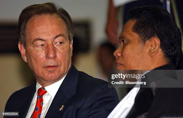 Richard Ness, President Director of PT. Newmont Minahasa Raya, left, speaks with his lawyer Luhut Pangaribuan, right, shortly after arriving at court...