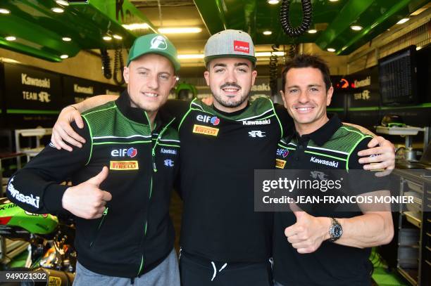 French riders Randy de Puniet, Jeremy Guarnoni and Mathieu Gines poses in their pit after Randy de Puniet clocked the best laps time in 1'36.446 on...