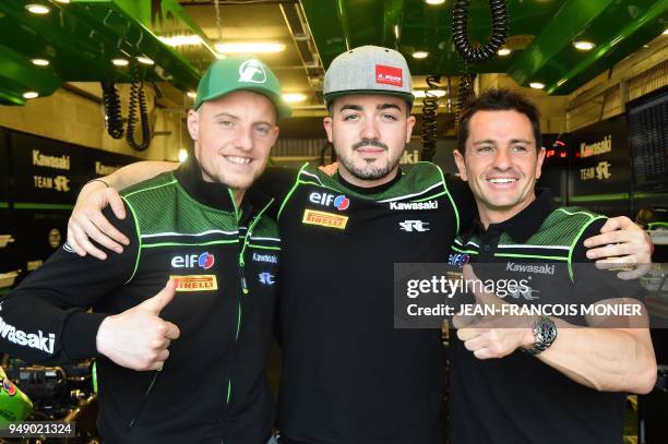 French riders Randy de Puniet, Jeremy Guarnoni and Mathieu Gines poses in their pit after Randy de Puniet clocked the best laps time in 1'36.446 on...