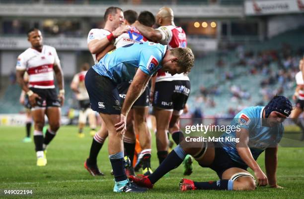 Michael Hooper and Michael Wells of the Waratahs look dejected after a Lions try during the round 10 Super Rugby match between the Waratahs and the...
