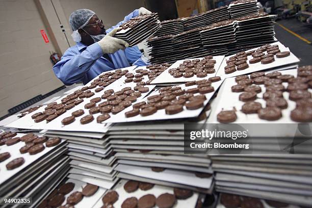 An employee stacks sheets of cooled chocolate at the kosher certified Madelaine Chocolate Novelties, Inc. Factory in the Queens borough of New York,...