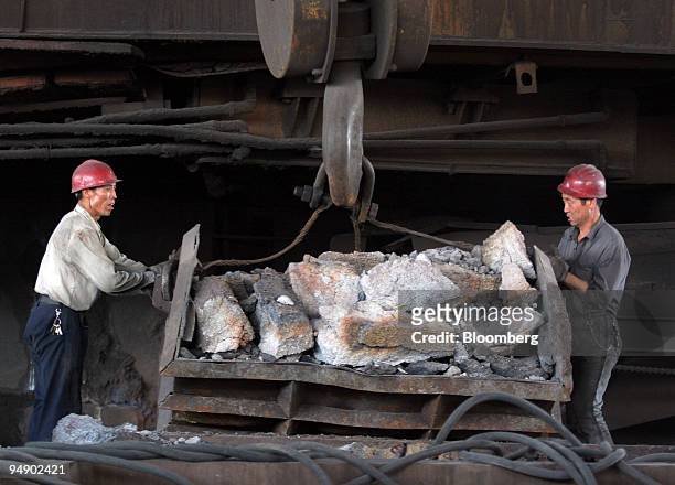 Workers at the Inner Mongolian Baotou Steel Union Co. Ltd. Load raw material into a smelter in Baotou, Inner Mongolia, China, on Thursday, August 18,...
