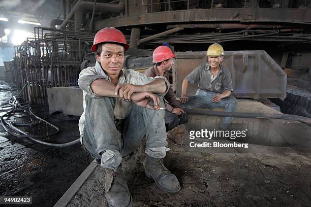 Workers at the Inner Mongolian Baotou Steel Union Co. Ltd. Have a cigarette break on Thursday, August 18 in Baotou, Inner Mongolia, China.