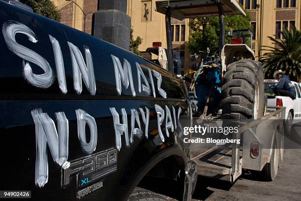 Truck pulling tractors from Gunajuato to participate in the protests against the North American Free Trade Agreement displays the words, "Without...