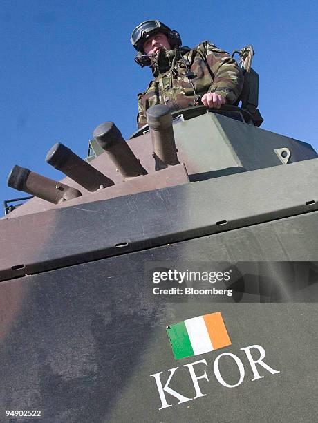 An Irish soldier, part of the KFOR security services, sits in an armored vehicle while patrolling the Serb enclave of Lipjan, Kosovo, on Thursday,...