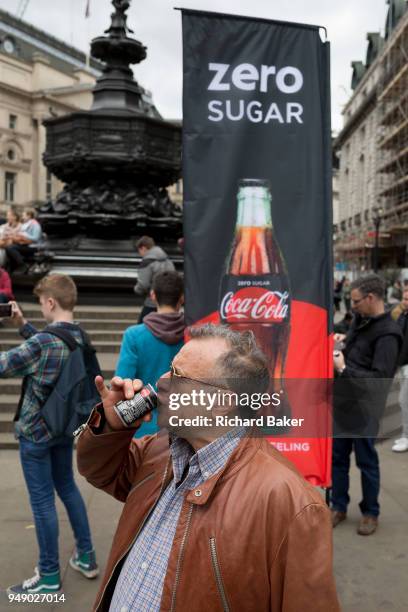 Passer-by tastes a sample of the new Zero Sugar Coca-Cola drinks, given out in Piccadilly Circus, on 16th April 2018, in London, England.