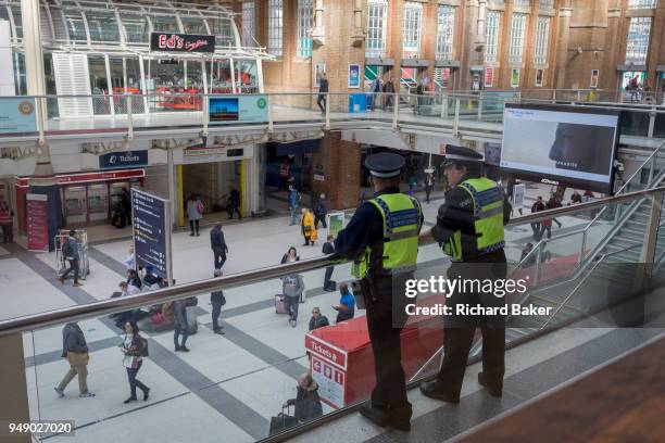 Special constables watch over concourse passengers at Liverpool Street mainline Station, on 17th April 2018, in the City of London, England.
