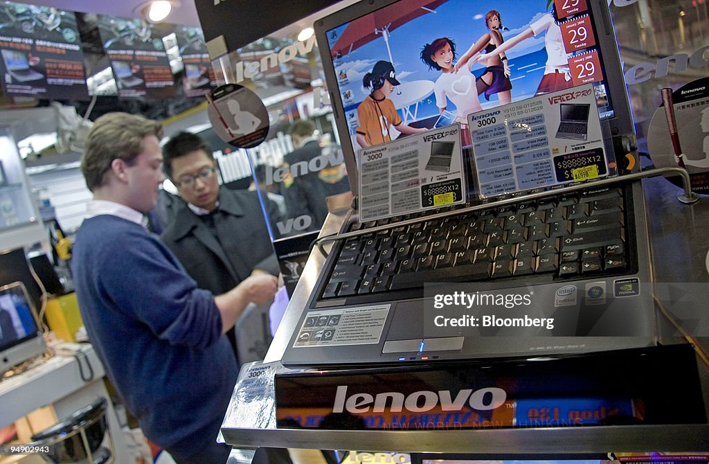 People browse a computer store where Lenovo Group laptop com