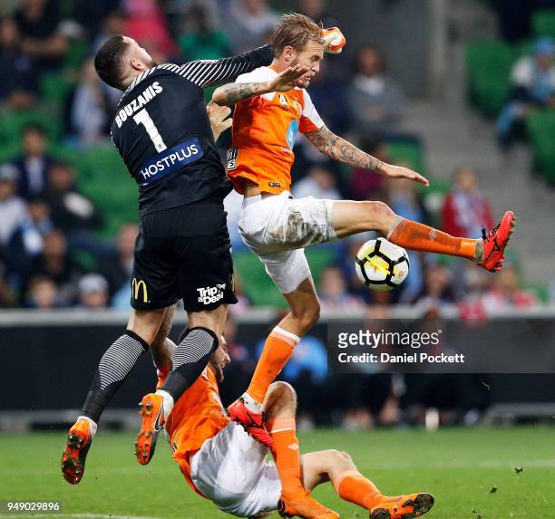 Jacob Pepper of Brisbane Roar and Melbourne City goalkeeper Dean Bouzanis contest the ball during the A-League Elimination Final match between the...