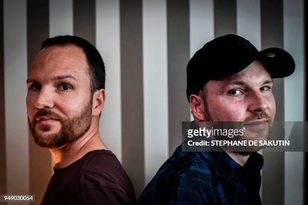 Twins Franck and Eric Dufourmantelle pose on April 20, 2018 in Paris. Franck, a 33-year-old who had suffered burns over 95 percent of his body was...