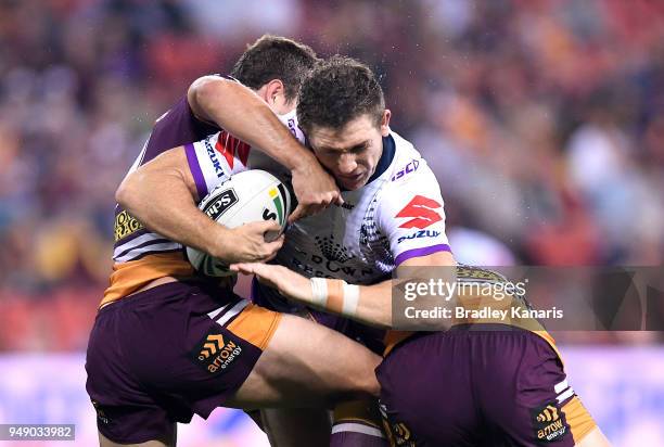 Ryan Hoffman of the Storm takes on the defence during the round seven NRL match between the Brisbane Broncos and the Melbourne Storm at Suncorp...