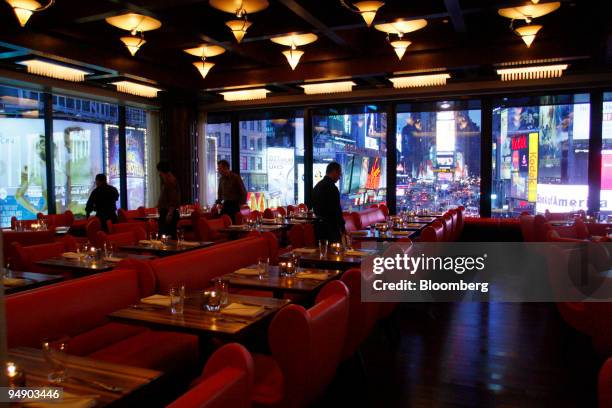 Waiters prepare the dining room for service at Chop Suey overlooking Time Square in New York, U.S., on Saturday, Jan. 26, 2008. Irony might be the...