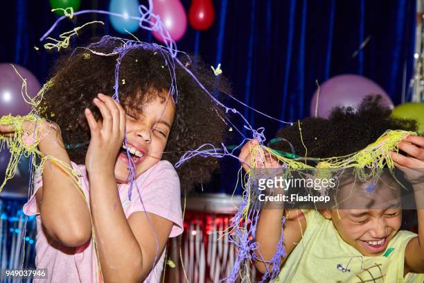 portrait of two girls at a party - party string stock pictures, royalty-free photos & images