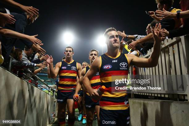 Myles Poholke, Jordan Galluci and Taylor Walker of the Crows walk down the tunnel during the round five AFL match between the Sydney Swans and the...
