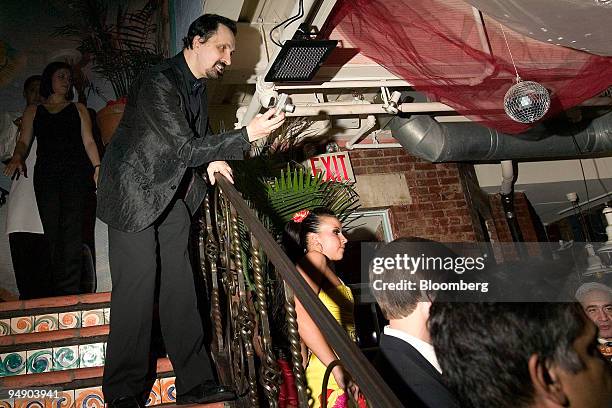 Stefano Spadoni takes a photograph of the dance floor during a networking party in New York, U.S., on Tuesday, Feb. 5, 2008. Spandoni's goal is to...