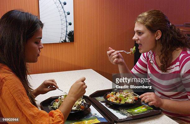 Two customers eat salads at a McDonalds in central London, Thursday July 22, 2004. McDonald's Corp., the world's largest restaurant chain, and...