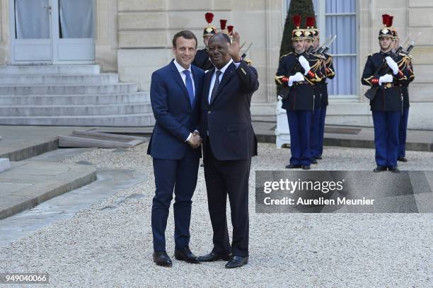 French President Emmanuel Macron welcomes Ivory Coast President Alassane Dramane Ouattara for a meeting at Elysee Palace on April 20, 2018 in Paris,...