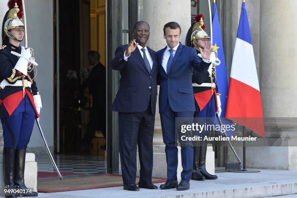 French President Emmanuel Macron welcomes Ivory Coast President Alassane Dramane Ouattara for a meeting at Elysee Palace on April 20, 2018 in Paris,...