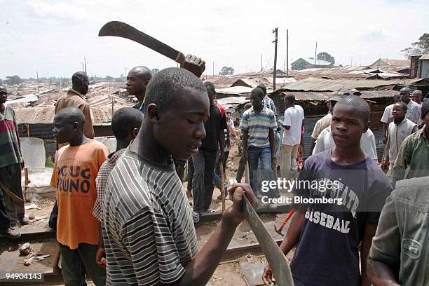 Opposition supporters hold weapons in the Kibera district of Nairobi, Kenya, on Tuesday, Jan. 29, 2008. Kenya's main opposition party appealed for...