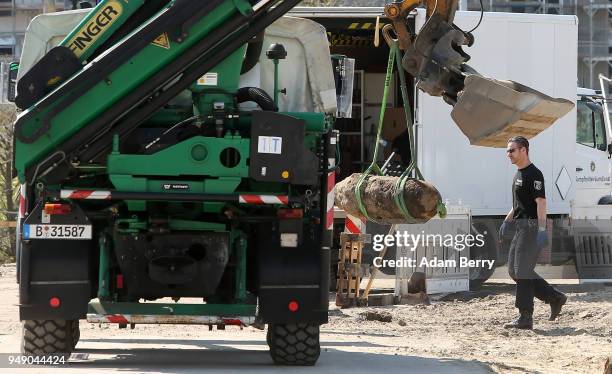 Police officer passes an unexploded 500-kilogram bomb from World War II after its deactivation on April 20, 2018 in Berlin, Germany. The bomb,...