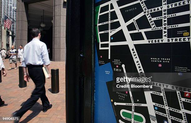 Man walks past an information map showing lower Manhattan in front of the Goldman Sachs building on Broad Street in the financial district of New...