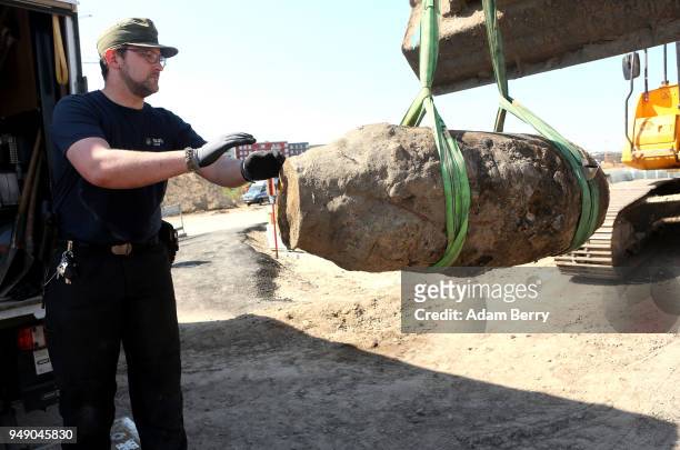 Bomb disposal technician steadies an unexploded 500-kilogram bomb from World War II after its deactivation on April 20, 2018 in Berlin, Germany. The...