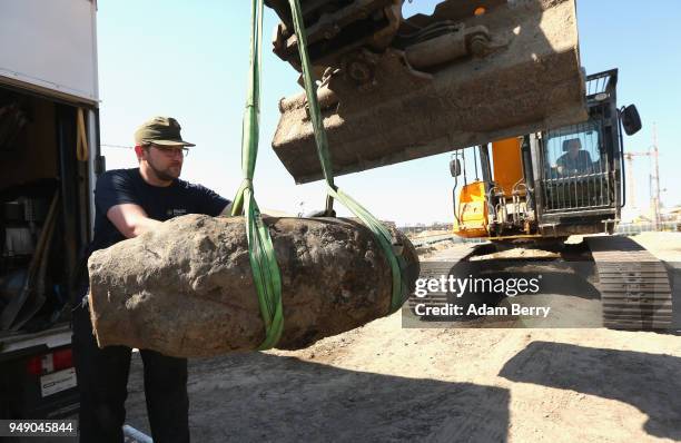 Bomb disposal technician steadies an unexploded 500-kilogram bomb from World War II after its deactivation on April 20, 2018 in Berlin, Germany. The...