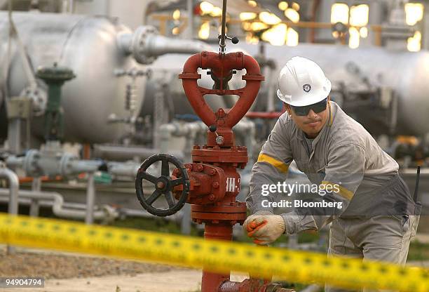 Chaco Co. Employee tests fire-fighting equipment at a gas plant in the tropical region of Chapare, Bolivia Friday, July 16, 2004. Bolivians voted on...