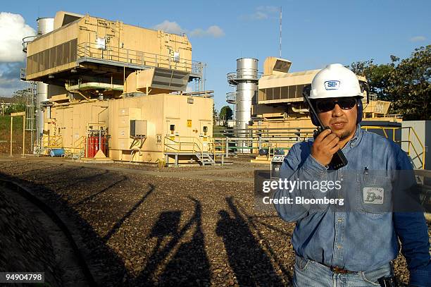 Compania Electrica Central Bulo Bulo S.A. Employee speaks on his radio at the company's methane gas thermo-electrical power station in the tropical...