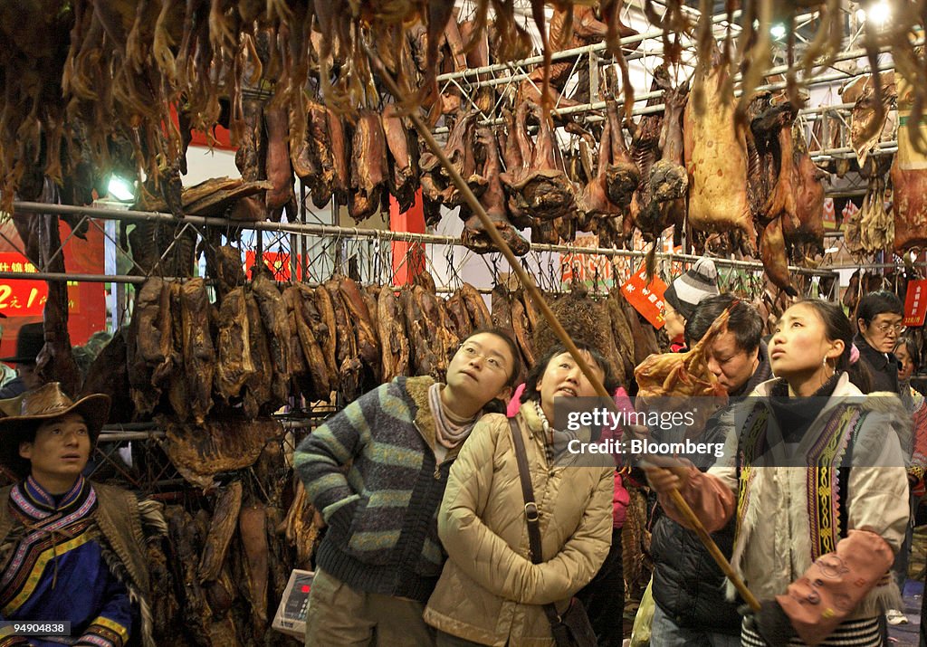 People browse cured and salted meats at a Lunar New Year foo