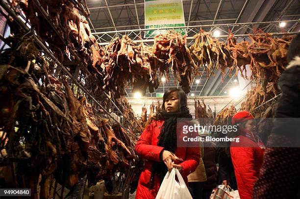 Woman browses cured and salted meats at a Lunar New Year food fair in Chengdu, China, on Sunday, Jan. 27, 2008. The year of the Rat begins on Feb. 7,...