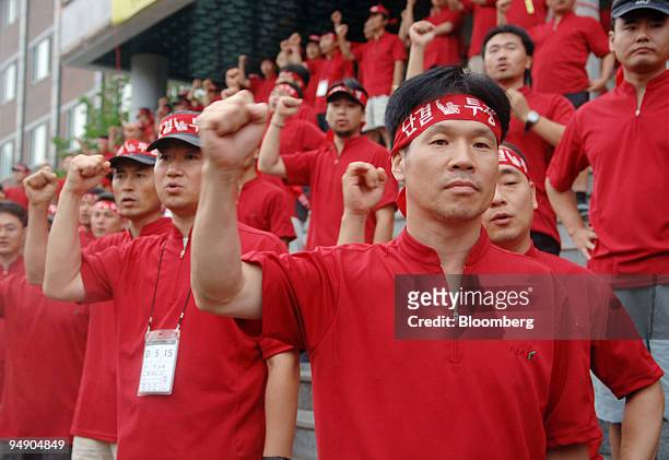 Asiana Airline Inc. Pilot union members chant slogans to welcome the union leader Kim Young Keun's arrival at the strike headquarters in Boeun,...