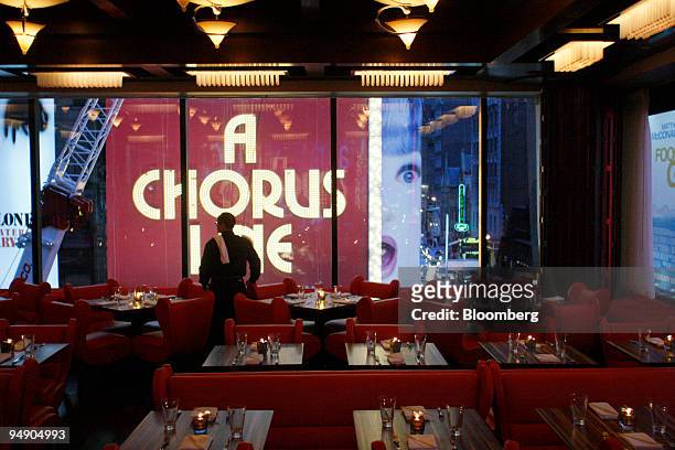 Waiters prepare the dining room for service at Chop Suey overlooking Time Square in New York, U.S., on Saturday, Jan. 26, 2008. Irony might be the...