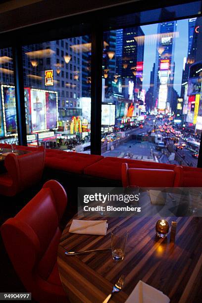 Tables are set for dinner service at Chop Suey overlooking Time Square in New York, U.S., on Saturday, Jan. 26, 2008. Irony might be the next logical...