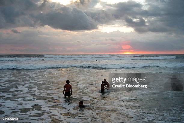 Beach-goers play in the Pacific Ocean during sunset in Playa Guiones, Nosara, Costa Rica, on Dec. 26, 2007. Costa Rica, located between Nicaragua and...