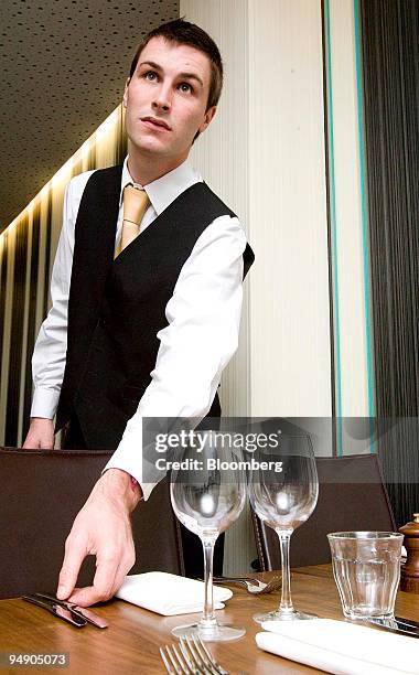 Jean-Marie Messaoud, the Chef de Rang, adjusts cutlery at chef Gordon Ramsay's restaurant 'Foxtrot Oscar' in London, U.K. On Thursday, Jan. 24, 2008....