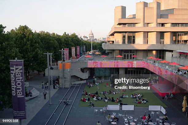 Signs advertising the 10 pound season sponsored by Travelex can be seen outside of the National Theatre in London, England, on Monday, August 8,...