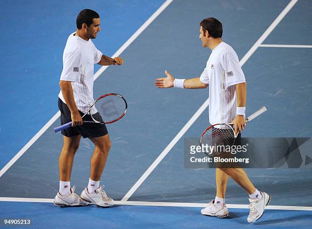 Andy Ram, left, and Jonathan Erlick of Israel congratulate each other on winning a point against Arnaud Clement and Michael Llodra of France in the...