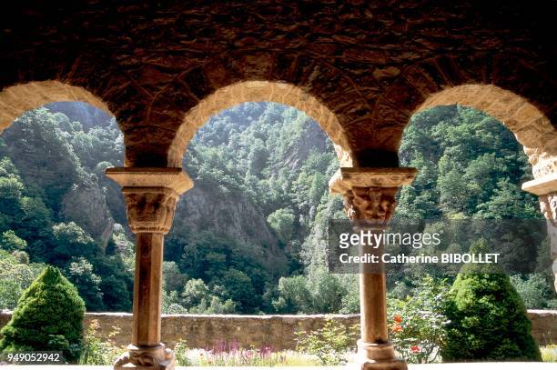 The Benedictine abbey of Saint Martin du Canigou on its rocky spur in the Pyrenees. The southern gallery and its white marble capitals from the...