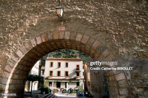 The village of Villefranche-de-Conflent seen through a gate of the ramparts . Pays catalan: le village de Villefranche-de-Conflent à travers une...