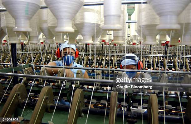 Workers monitor the cotton spinning process, July 13 on the Dois Meninos farm in Ituverava, a region 250 miles from Sao Paulo, Brazil. President...