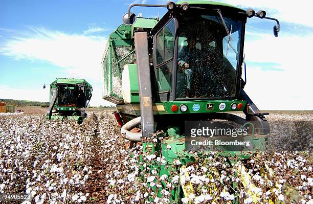 Cotton picking machines run through a field July 13, 2004 on the Dois Meninos farm in Ituverava, a region 250 miles from Sao Paulo, Brazil. Halting...