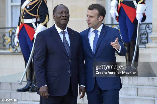 French President Emmanuel Macron escorts Ivory Coast President Alassane Dramane Ouattara after a meeting at Elysee Palace on April 20, 2018 in Paris,...