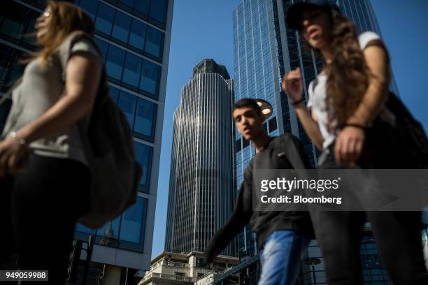 Pedestrians pass in view of Tower 42 in the City of London, U.K., on Friday, April 20, 2018. Foreign investors are less worried about the impact of...