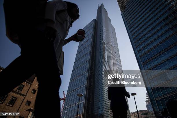 Pedestrians pass in view of the Heron Tower in the City of London, U.K., on Friday, April 20, 2018. Foreign investors are less worried about the...
