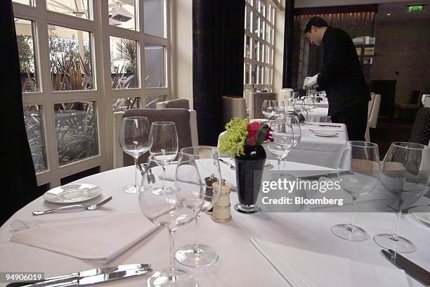 Staff set tables in preparation for the lunchtime crowd at The Ledbury restaurant in the Notting Hill section of London, on Monday, August 1, 2005....