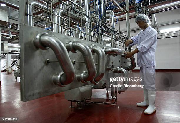 Man works at a factory making powdered milk in Inner Mongolia, China, on Thursday, July 5, 2007. China found the industrial chemical melamine in...